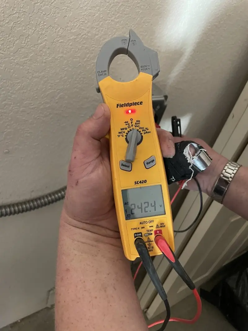 Voltage testing with clamp meter during Outlet Installation in Englewood